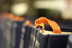 "Bookmark" by Quinn Dombrowski is licensed under CC BY-SA 2.0 Image of books on a shelf with bookmarks between the pages