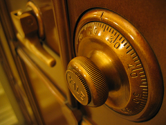Lock on a safe -- 'Safe' by rpongsaj is licensed under CC BY 2.0 Image of a heavy combination lock on a safe